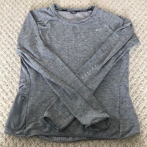 Nike long sleeve running shirt with side pocket.